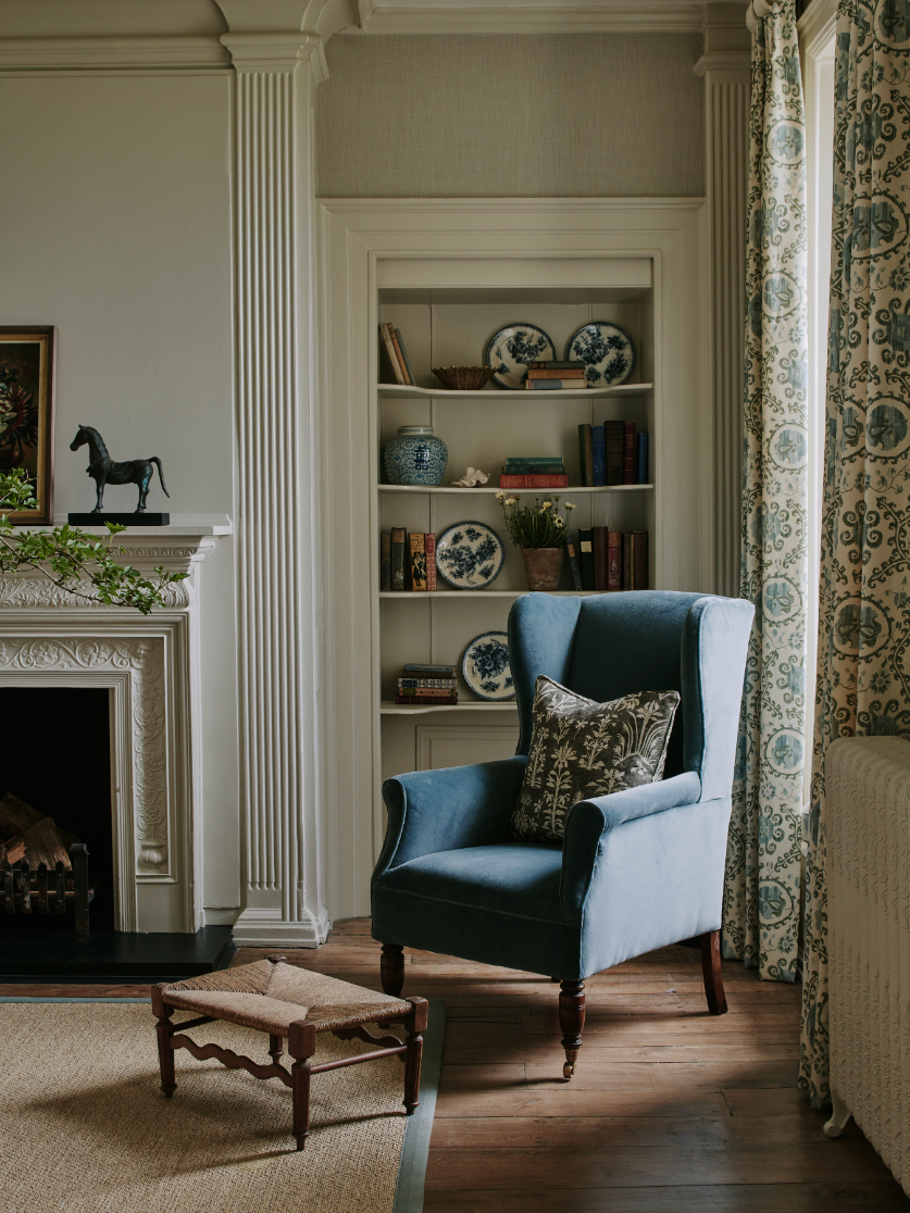 sims-hilditch-interior-design-cotswold-family-manor-hallway-armchair-portrait