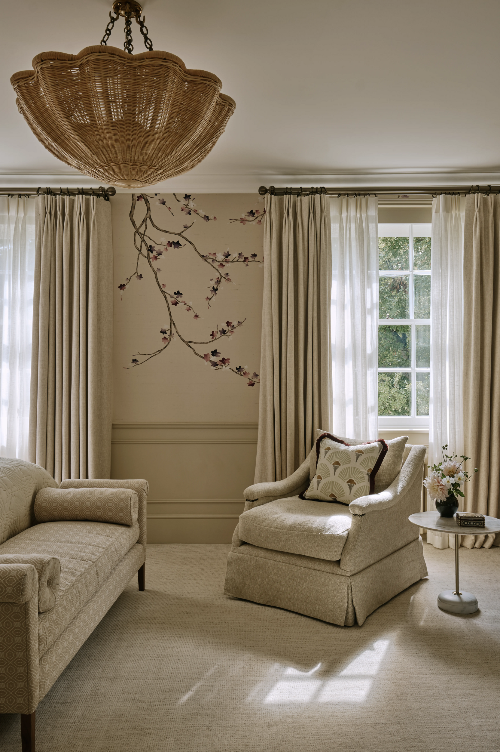 pccassional-chair-in-master-bedroom-with-cherry-blossom-wakkpaper-and-scalloped-rattan-lampshade-in-south-kensington-family-home-project