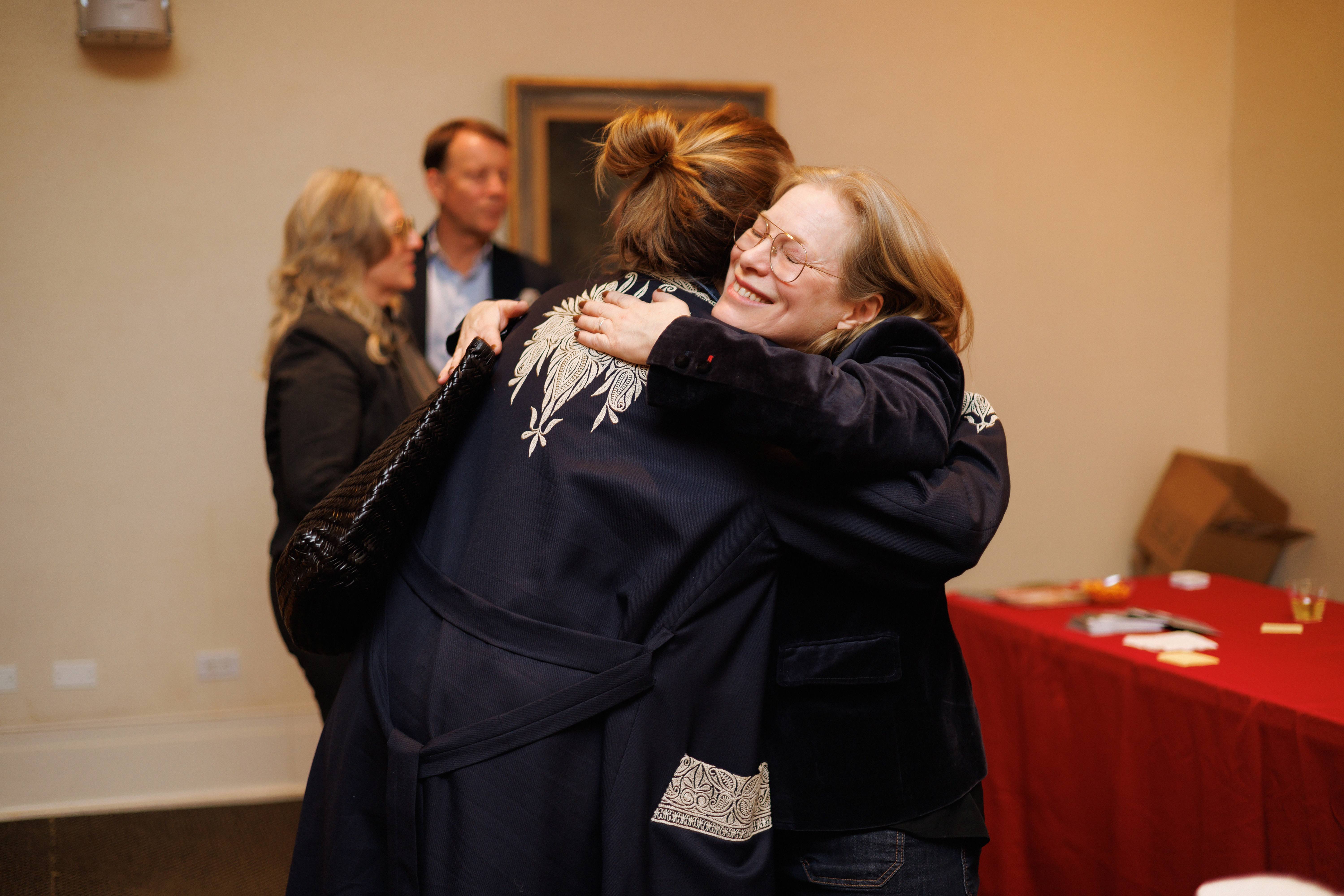 Guests Hugging At Emma Sims Hildtch Book Talk New York