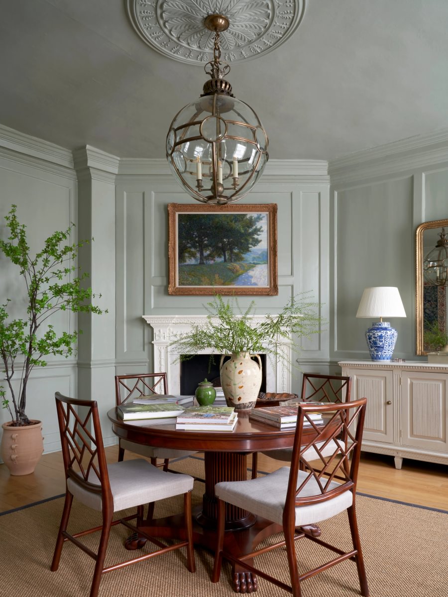 Sims Hilditch Interior Design Table with Wooden Chairs and Fireplace
